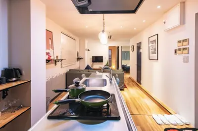 a kitchen with a sink and a stove top oven at Skytree Tatami Hotel in Tokyo