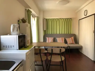 a small kitchen with a table and a couch at Uhome Iriya Apartment in Tokyo
