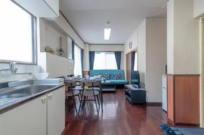 a kitchen and living room with a table and chairs at Uhome Iriya Apartment in Tokyo
