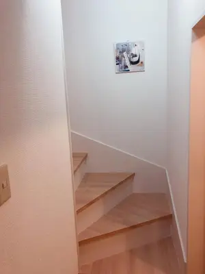 a stairwell with wooden steps in a house at C.H.House in Tokyo