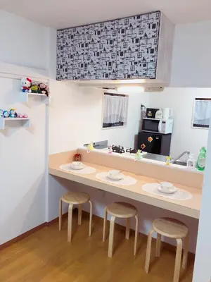 a kitchen with two stools and a counter with a counter top at C.H.House in Tokyo