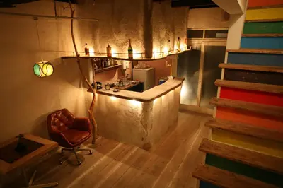 a kitchen with a counter and a chair in a room at Guesthouse toco in Tokyo