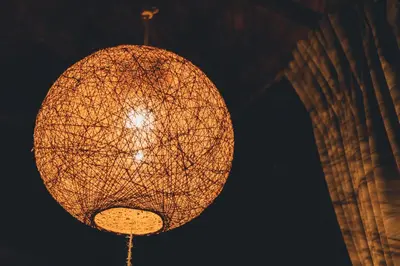 a lit up lantern hanging from a building at night at Guesthouse toco in Tokyo