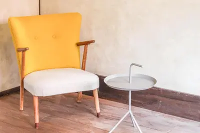 a yellow chair sitting next to a small table at Guesthouse toco in Tokyo