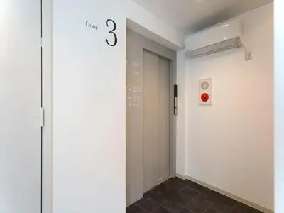 a hallway with a door with the number three on it at CHA-AN HOTEL UENO in Tokyo