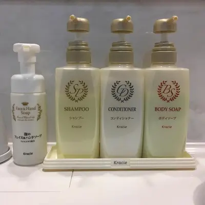 a group of four bottles of soap on a shelf at Shinbashi Urban Hotel in Tokyo