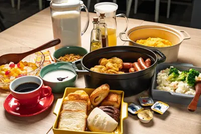 a table with a bunch of food on it at Grids Tokyo Ueno Hotel&Hostel in Tokyo