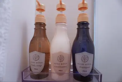 three bottles of wine sitting on a shelf at Mitsuba Guest House in Tokyo