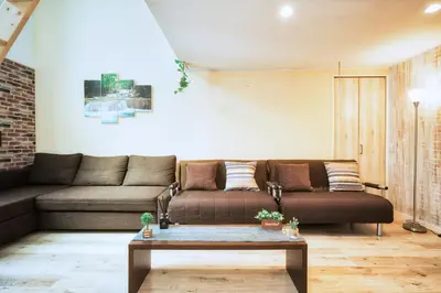 a living room with a couch and a coffee table at nestay house tokyo itabashi 01 in Tokyo