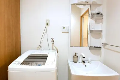 a small bathroom with a sink and a mirror at nestay house tokyo itabashi 02 in Tokyo