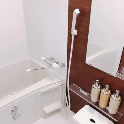a bathroom with a toilet and a sink and a mirror at nestay house tokyo itabashi 02 in Tokyo