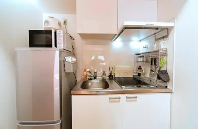 a small kitchen with a sink and a refrigerator at nestay house tokyo itabashi 02 in Tokyo