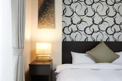 a bedroom with a bed and a table with a lamp at 22-Sweet Dreams House in JR Okubo Station 5 min in Tokyo