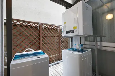 a microwave oven sitting on top of a washing machine at 22-Sweet Dreams House in JR Okubo Station 5 min in Tokyo