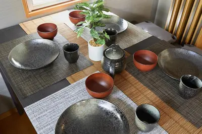 a table with bowls and potted plants on it at 22-Sweet Dreams House in JR Okubo Station 5 min in Tokyo