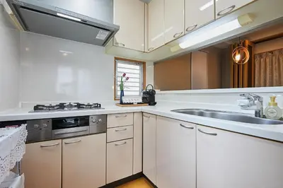 a kitchen with white cabinets and a sink at 22-Sweet Dreams House in JR Okubo Station 5 min in Tokyo