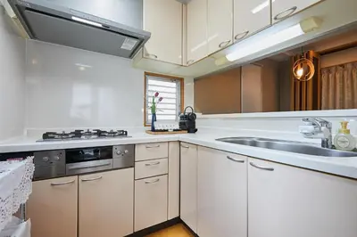 a kitchen with white cabinets and a sink at 22-Sweet Dreams House in JR Okubo Station 5 min in Tokyo