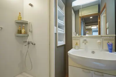 a bathroom with a sink and a shower at 22-Sweet Dreams House in JR Okubo Station 5 min in Tokyo