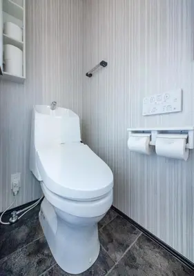 a bathroom with a toilet and two rolls of toilet paper at Calm Asakusa Kaminarimon Gate CLx in Tokyo
