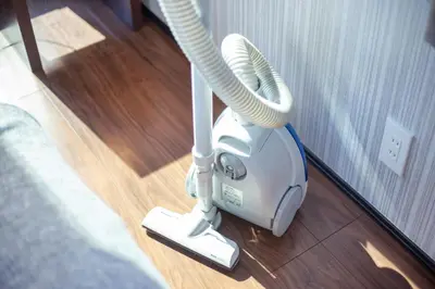 a vacuum sitting on the floor next to a mirror at Calm Asakusa Kaminarimon Gate CLx in Tokyo