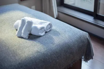 a pair of towels sitting on top of a bed at Calm Asakusa Kaminarimon Gate CLx in Tokyo