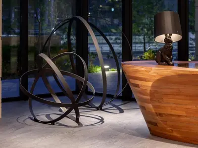 a black chair sitting next to a table with a lamp at Mitsui Garden Hotel Jingugaien Tokyo Premier in Tokyo
