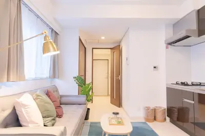 a living room with a couch and a table at Tokyo Sunshine Tower Premium Hotel in Tokyo