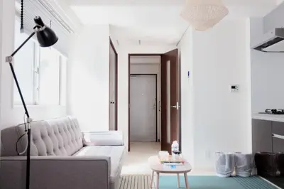 a living room with a white couch and a table at Tokyo Sunshine Tower Premium Hotel in Tokyo
