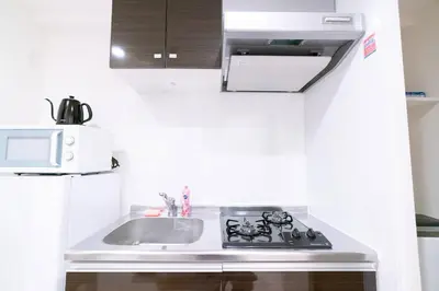a small kitchen with a sink and a microwave at Tokyo Sunshine Tower Premium Hotel in Tokyo