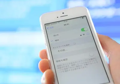 a person holding a cell phone in their hand at APA Hotel Ayase Ekimae in Tokyo