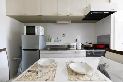 a kitchen with a table with two bowls on it at G-Shinkoiwa ColorBee Hostel4 4min to nearest station in Tokyo