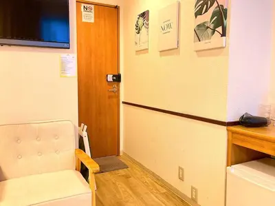 a room with a door and a chair and a table at KEYHOTEL-5minutes for walk to Akihabara Electric Town in Tokyo