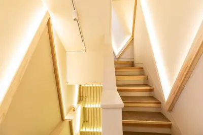 a staircase in a house with white walls and wooden stairs at KEYHOTEL-5minutes for walk to Akihabara Electric Town in Tokyo