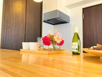 a bottle of wine and a vase of flowers on a counter at KEYHOTEL-5minutes for walk to Akihabara Electric Town in Tokyo