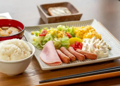 a plate of food with meat and salad and rice at Tabist TOKYO CITY VIEW HOTEL in Tokyo