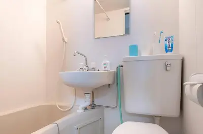 a bathroom with a sink and a toilet and a tub at Uhome Tabata Apartment in Tokyo
