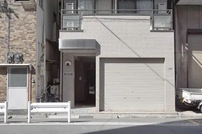 a building with a garage door on the side of it at ZAITO Tokyo Kinshicho Economy Inn \u5b85\u4e1c\u4e1c\u4eac\u6a2a\u5ddd1\u6c11\u5bbf in Tokyo