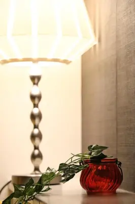 a red vase sitting on a table next to a lamp at Casa HANA in Tokyo