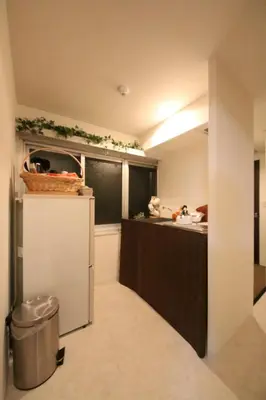 a small kitchen with a refrigerator and a sink at Casa HANA in Tokyo