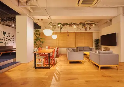 a living room with a table and chairs at Hotel Graphy Nezu in Tokyo