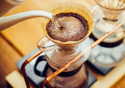 a glass cup filled with coffee on a table at Hotel Graphy Nezu in Tokyo