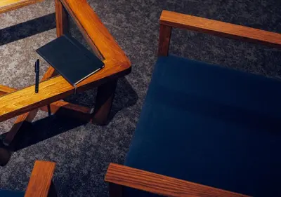 an overhead view of a desk with a book and a pen at Hotel Graphy Nezu in Tokyo