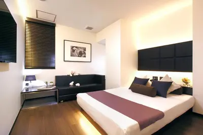a bedroom with a large bed and a desk at Hotel DUO kinsicho in Tokyo
