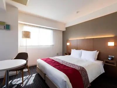 a hotel room with a large bed and a table at Tokyu Stay Monzen-Nakacho Tokyo in Tokyo