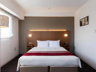 a bedroom with a large bed with a red blanket at Tokyu Stay Monzen-Nakacho Tokyo in Tokyo
