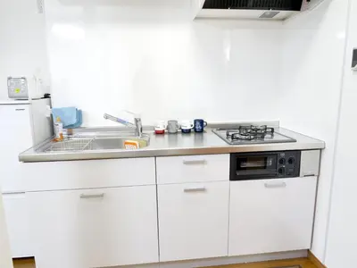 a white kitchen with a sink and a stove at Triphome Ikebukuro Tokyo Max 7ppls FREE WIFI in Tokyo