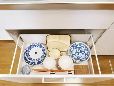 a drawer filled with plates and bowls on a table at Triphome Ikebukuro Tokyo Max 7ppls FREE WIFI in Tokyo