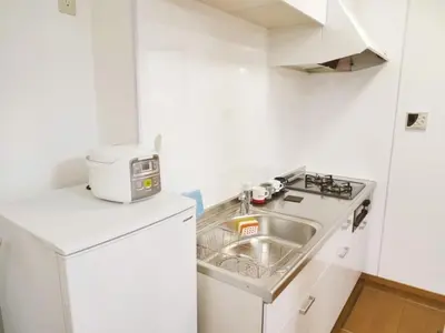 a small kitchen with a sink and a microwave at Triphome Ikebukuro Tokyo Max 7ppls FREE WIFI in Tokyo