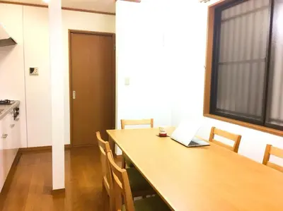 a dining room with a table with a laptop on it at Triphome Ikebukuro Tokyo Max 7ppls FREE WIFI in Tokyo