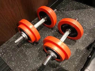 two orange dumbbells on top of a counter at Hotel Adonis Tokyo - Dormitory Share Room For Male Only At City Center in Tokyo
